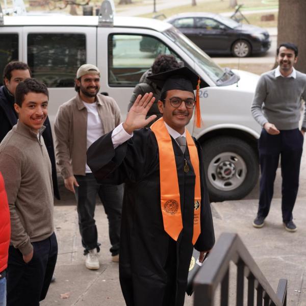 Waving graduate outside