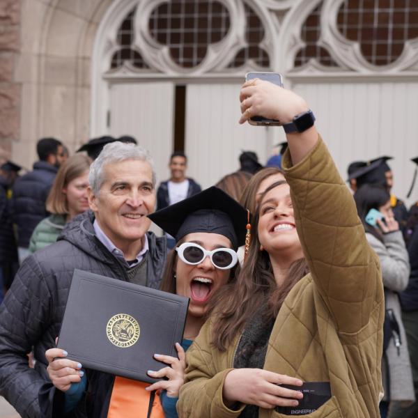 Grad taking selfie