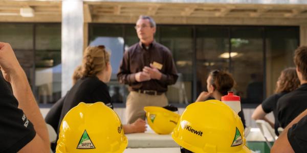 Yellow hard hats with Kiewit logo. 