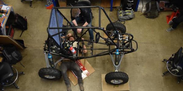 Students working on a car in the lab