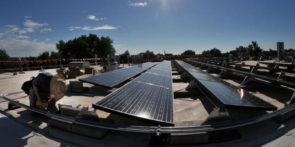 Person adjusts solar panels