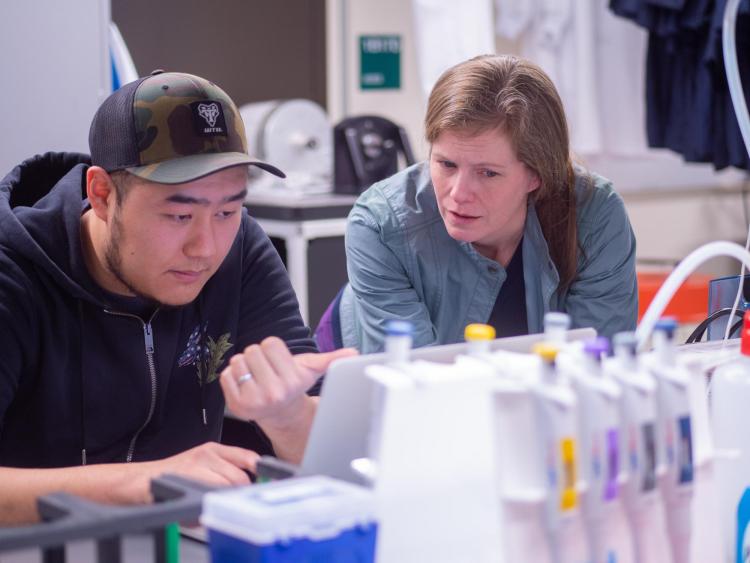 Lynch and student in the lab