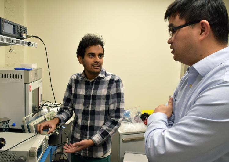 Xiaoyun Ding in the lab with his student.