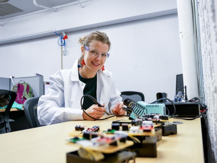 Architectural engineering PhD student Margarite Jacoby working on a board controller.