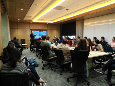 conference room with people watching a presentation