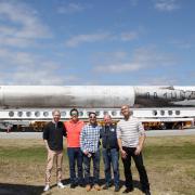 Members of the science and implementation team at Kennedy Space Center with a space-proven Falcon 9 rocket on the background. From left to right: Eric Yarns (KU), Kevin Ngo (KU), Luis Zea (CU), Dr. Joe Tash (KU), and Sam Piper (CU)