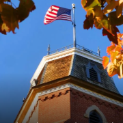 A USA flag flying over CU Boulder campus