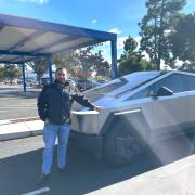 Ben Mousseau standing next to a Tesla
