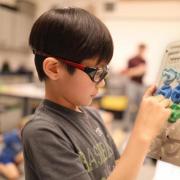 Jaejune Lee plays with a prototype of the Rain Game. (Credit: Jade Cody/Boulder Valley School District)