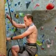 Andrew Dahir climbs on the climbing wall during his record attempt