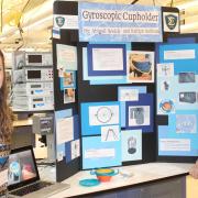 Students with gyroscopic cup holder project