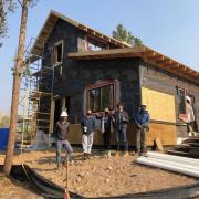 Students in front of a zero energy home they are building