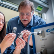 Alan W. Weimer in his lab with a student 