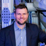 Paul Lichty sits in front of ALD equiment at Forge Nano.