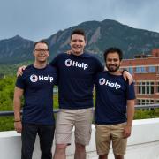 Fletcher Richman with Halp co-founders Tristan Rubadeau and Komran Rashidov on a balcony in Boulder with the Flatirons in the background.