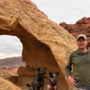 Ryan Hayward hiking with his two dogs.