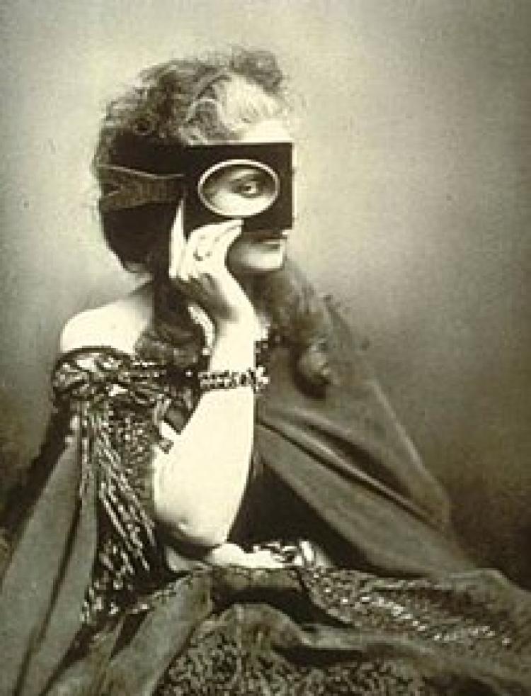 Photo of a woman in a dress covering her face with a mask