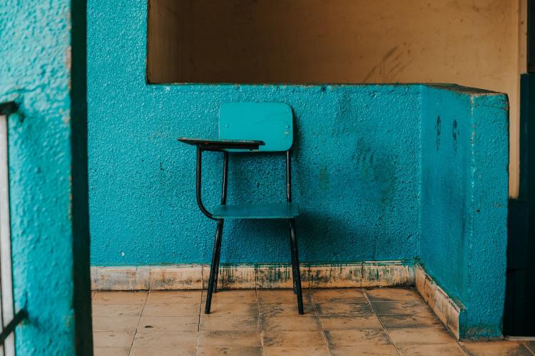A blue chair against a blue wall