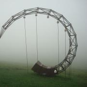 A horn-shaped wooden structure in a field