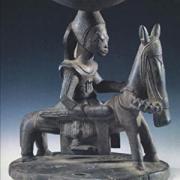 A sculpture of a person on a horse with the words, "Death and the King's Horseman" written below it