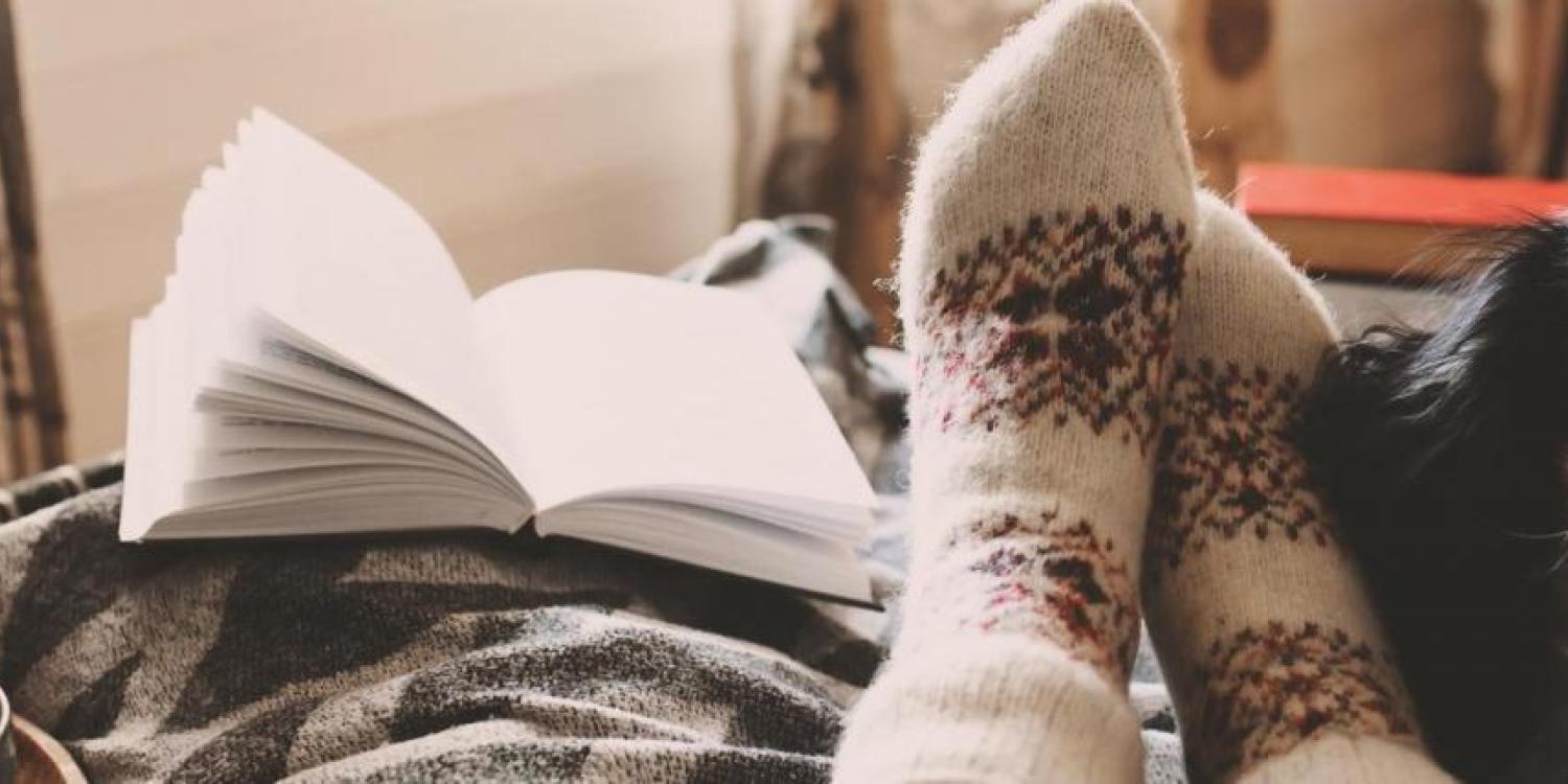 Stock image: cozy sock, warm cup, cute puppy