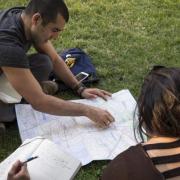 Assistant Professor, Alicia Gonzales and Kristina Lu view a map of Santiago