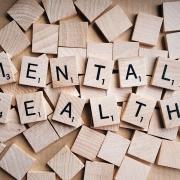 scrabble tiles spelling the words "mental health"