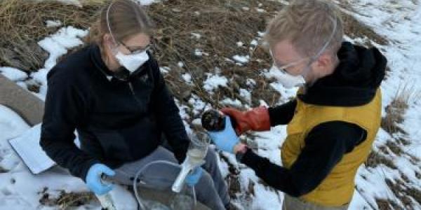 Researchers Julie Korak and Cresten Mansfeldt collect surface water samples on the Coal Creek waterway.