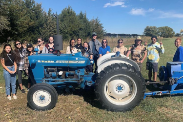 Seven students at a farm.