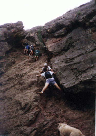 One of Dr. Moddel's students climbing up a rock during a hike