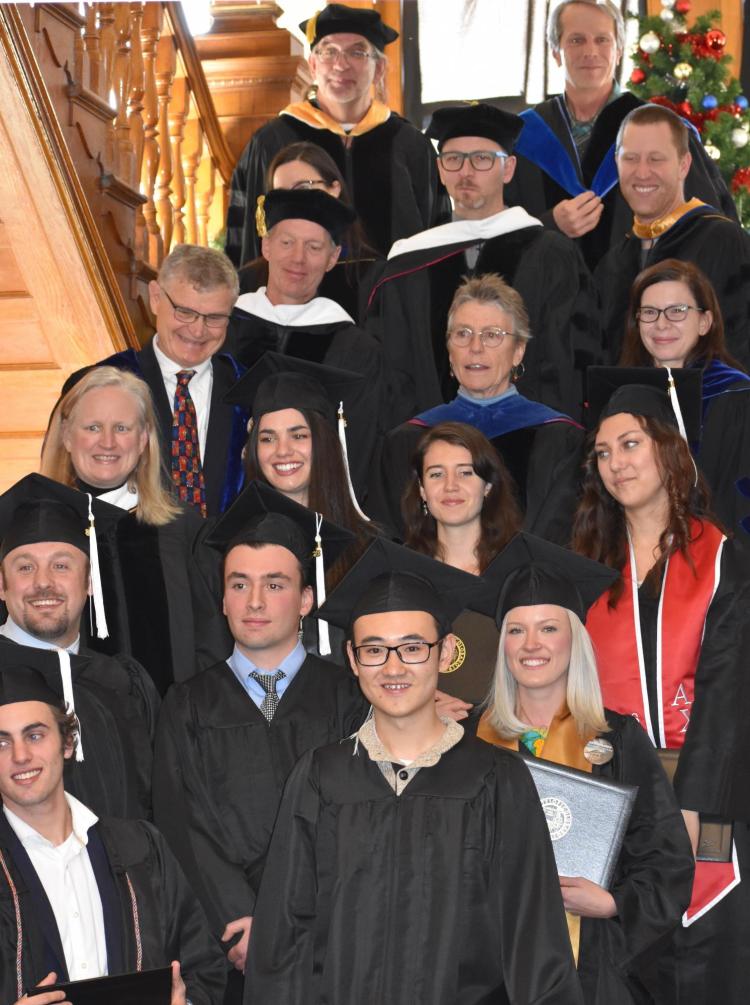 Group of students and faculty in caps and gowns