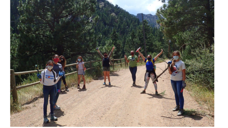 People standing on a dirt road.