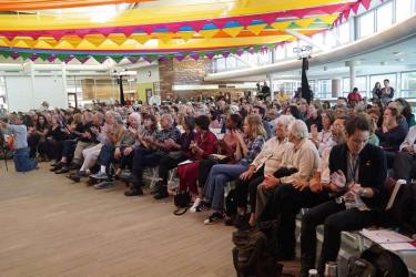 An audience sitting in chairs