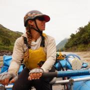 Woman rowing raft on river