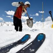 Researcher shoveling in the mountain snow