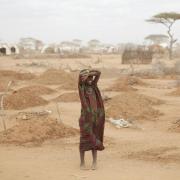 African woman standing in drought-affected area