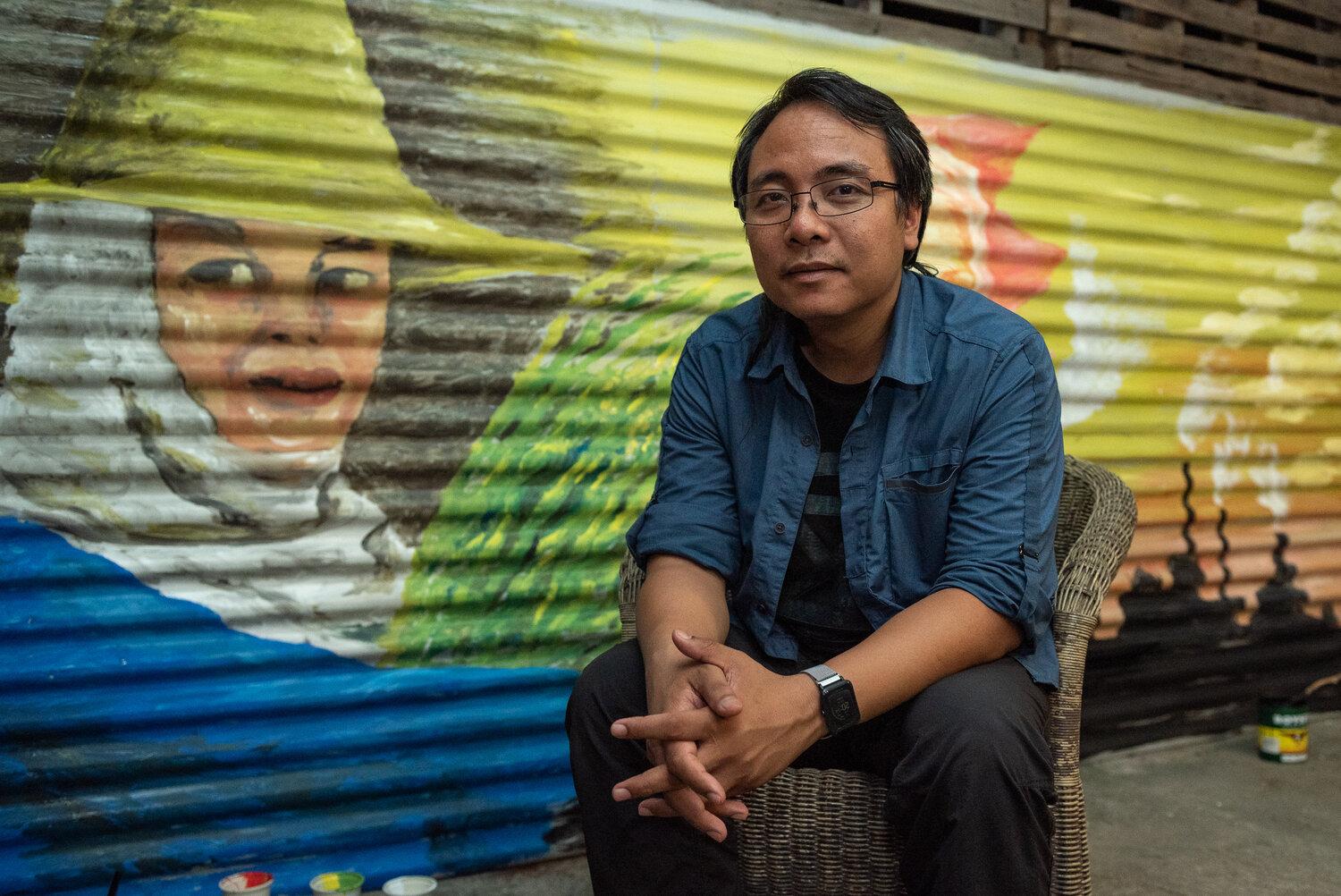 Yeb Saño sitting in front of mural