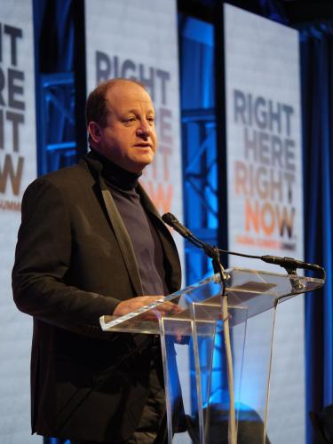 Colorado Governor Jared Polis speaks at the opening session at the Right Here Right Now Climate Summit