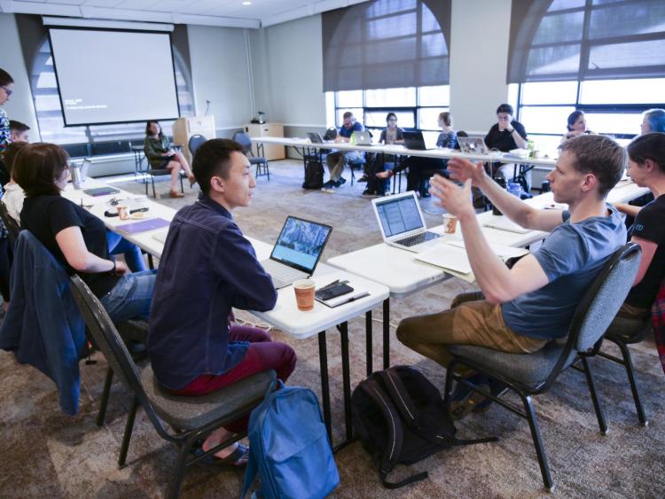 Graduate students engaged in discussion during dissertation writing retreat.