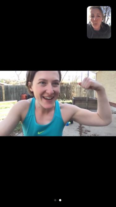 Sarah flexes her bicep during a Zoom call with a friend