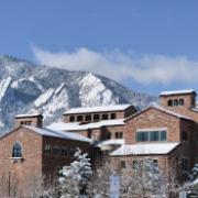Campus buildings with flatirons in the background