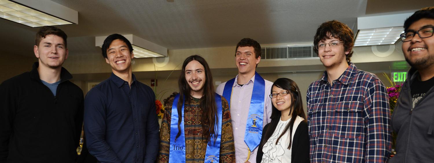 recent graduates share a laugh at a celebration dinner