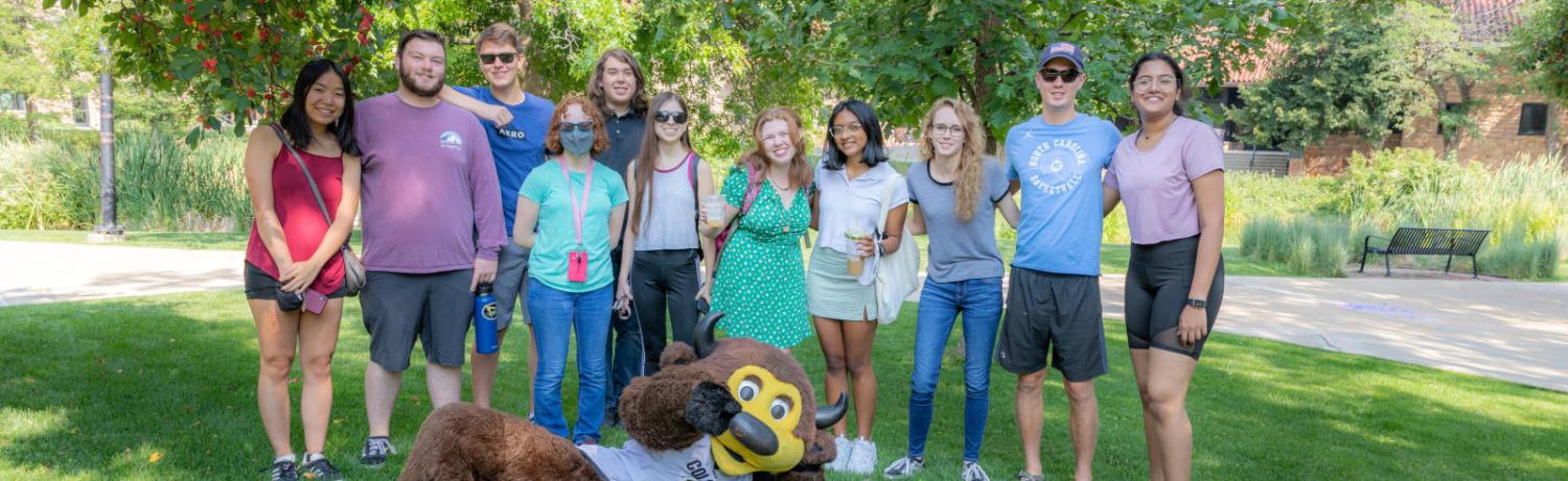 Photo of a group of students posing with Chip the Buffalo on Farrand Field.