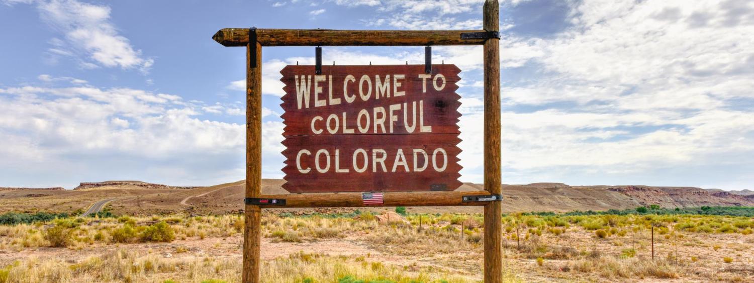 Photo of the "Welcome to Colorful Colorado" sign on a sunny bright day.