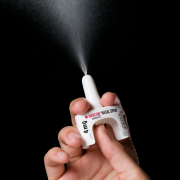 Photo of a person demonstrating how naloxone nasal spray works.