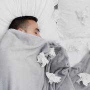 Man in bed with tissues