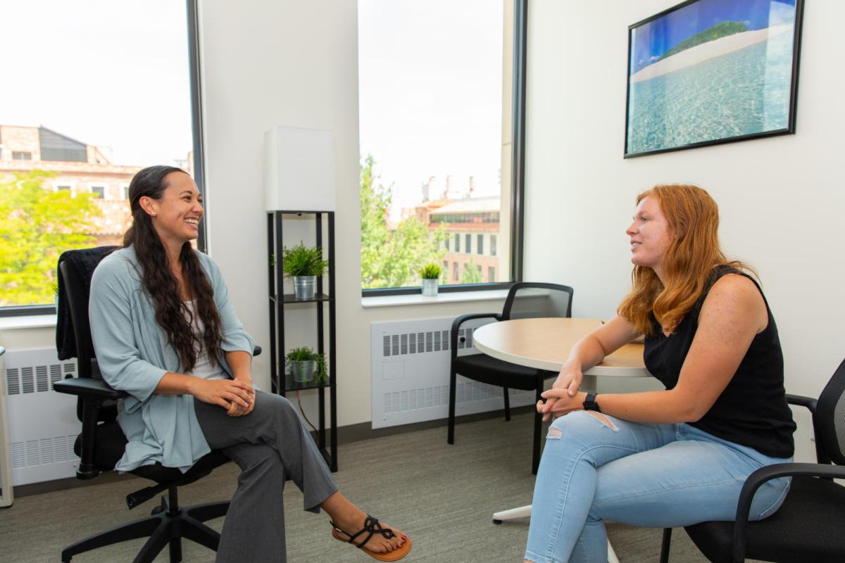 Photo of a student meeting with a staff member
