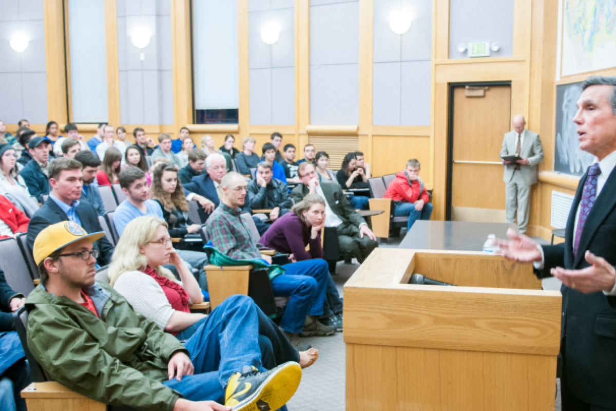 Students look at a speaking presenter