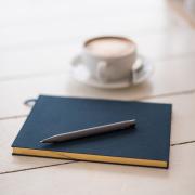 latte and notebook on table