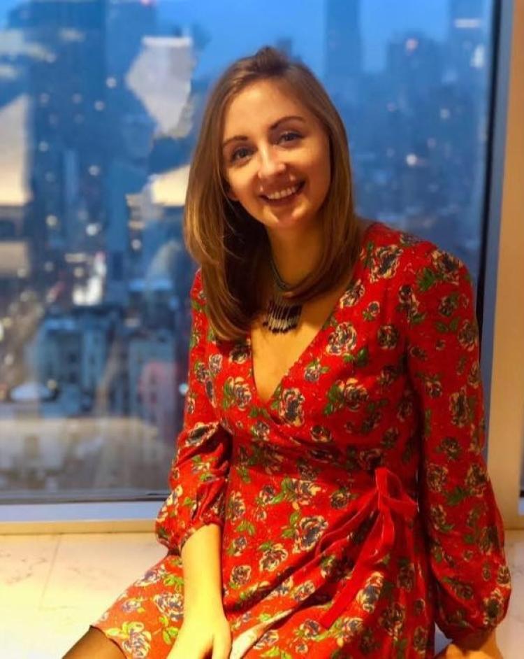 photo of erin neale wearing red dress in windowsill
